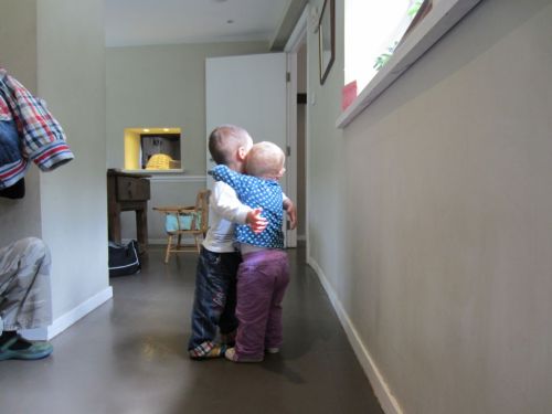 Two toddlers share a hug
